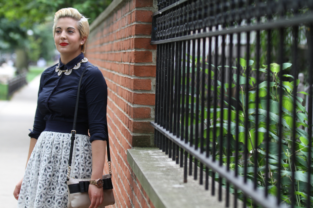 A woman looking happy and hopeful on the sidewalk